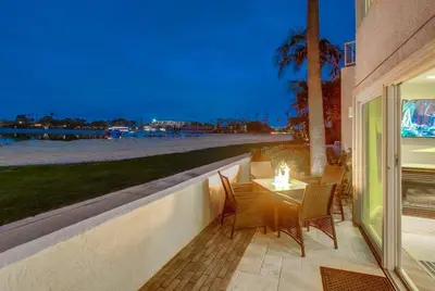 a patio with a table and chairs and the beach at Jamaica Sands WINTER SPECIAL! in San Diego