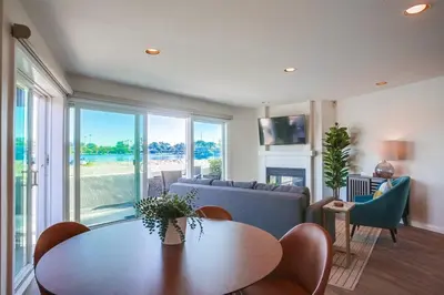 a living room with a table and a couch at Jamaica Sands WINTER SPECIAL! in San Diego