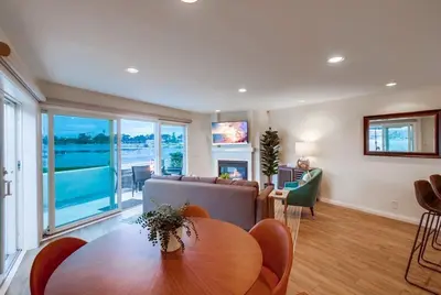 a living room with a table and a couch at Jamaica Sands WINTER SPECIAL! in San Diego