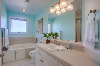 a bathroom with a sink and a tub and a toilet at Jamaica Sands WINTER SPECIAL! in San Diego