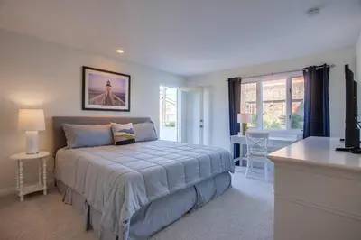 a bedroom with a bed and a television in it at Jamaica Sands WINTER SPECIAL! in San Diego