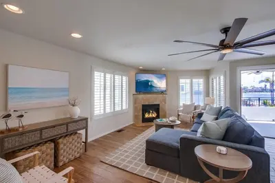 a living room with a blue couch and a fireplace at Kennebeck Cove in San Diego