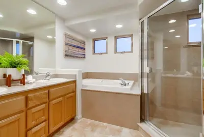 a bathroom with a shower and a sink and a tub at Kennebeck Cove in San Diego