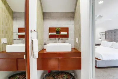 a bathroom with a sink and a bed at Kettner Row 1 in San Diego