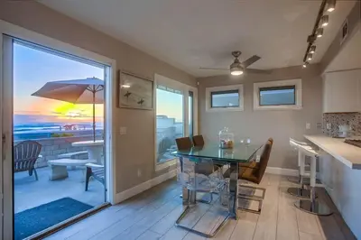 a dining room with a table and a view of the ocean at Life's A Beach 1 in San Diego