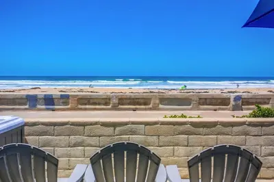 two chairs and an umbrella on the beach at Life's A Beach 1 in San Diego