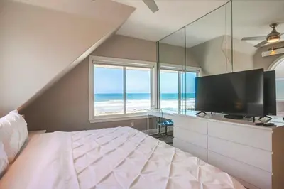 a bedroom with a large bed and a television at Life's A Beach 1 in San Diego