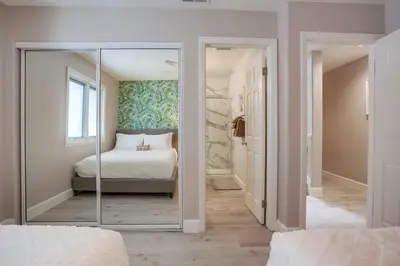 a bedroom with a bed and a mirror in it at Life's A Beach 1 in San Diego