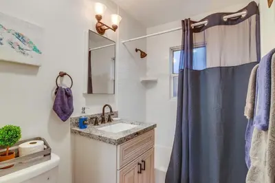 a bathroom with a sink and a shower curtain at Marina 1 in San Diego
