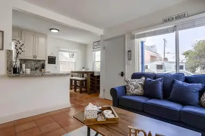 a living room with a blue couch and a kitchen at Marina 1 in San Diego