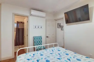 a bedroom with a bed and a tv on the wall at Marina 1 in San Diego