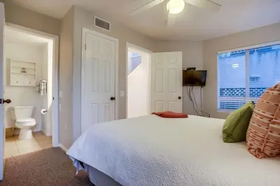 a bedroom with a white bed and a toilet at Palms Paradise 1 in San Diego