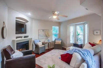 a living room with a couch and a fireplace at Palms Paradise 1 in San Diego