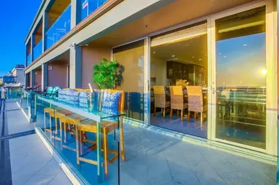 a table and chairs on the outside of a building at Residence Club 1 in San Diego