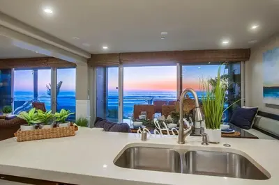 a kitchen with a sink and a view of the ocean at Residence Club 1 in San Diego