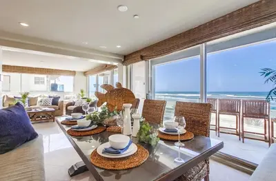 a dining room with a table with a view of the ocean at Residence Club 1 in San Diego
