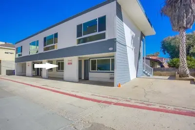 a large white building on a street at Strandway Suite 2 in San Diego