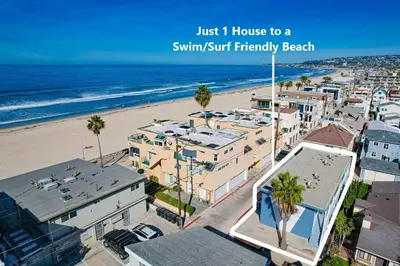 a view of a beach with palm trees and buildings at Strandway Suite 2 in San Diego