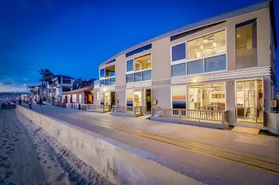 a white building on the beach at night at Surf Style 1 in San Diego