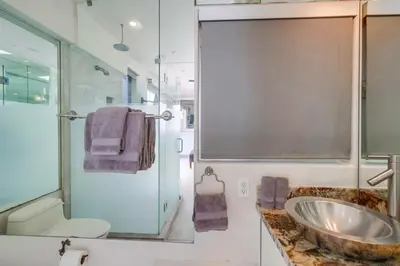 a bathroom with a sink and a glass shower at Surf Style 1 in San Diego