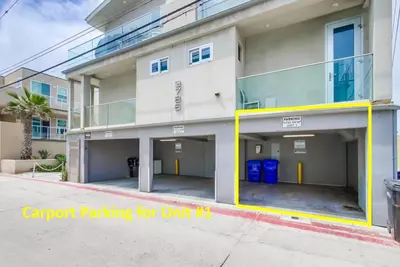 a building with a parking lot in front of it at Surf Style 1 in San Diego