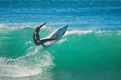 a man riding a wave on a surfboard in the ocean at Surf Style 1 in San Diego