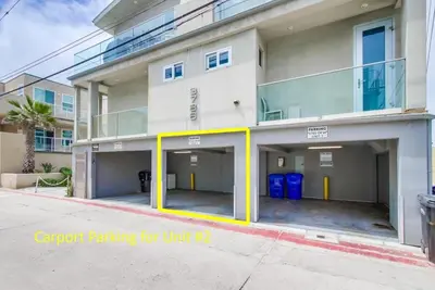 a building with two parking spaces in front of it at Surf Style 2 in San Diego