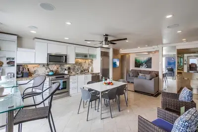 a kitchen and dining room with a table and chairs at Surf Style 2 in San Diego