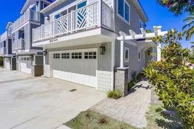 a large white house with a garage at The Shores 2 in San Diego