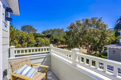 a balcony with a white fence and a chair at The Shores 2 in San Diego