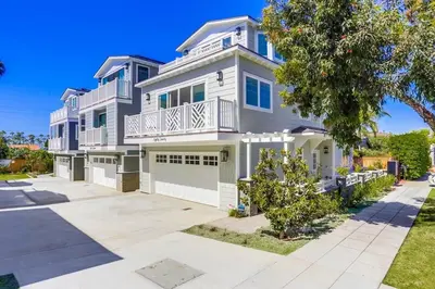 a large white house with a balcony at The Shores 2 in San Diego