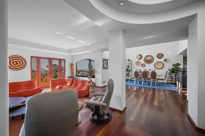 a living room with an orange couch and chairs at Stunning Ocean-View Villa, Walking to La Jolla Cove in San Diego
