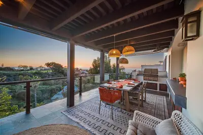 a patio with a table and chairs on a balcony at Stunning Ocean-View Villa, Walking to La Jolla Cove in San Diego