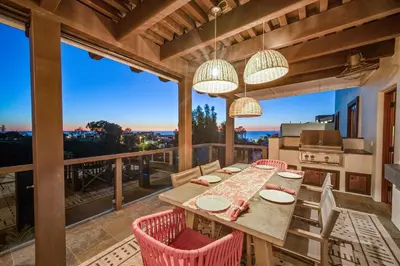 a dining room with a table and chairs on a balcony at Stunning Ocean-View Villa, Walking to La Jolla Cove in San Diego