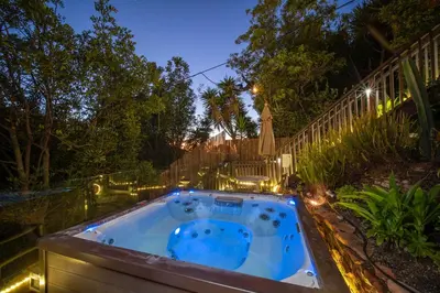 a backyard pool with a hot tub at night at Stunning Ocean-View Villa, Walking to La Jolla Cove in San Diego