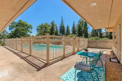a patio with a fence and a swimming pool at Designer Poolside 1Bed1Bth Retreat in La Mesa