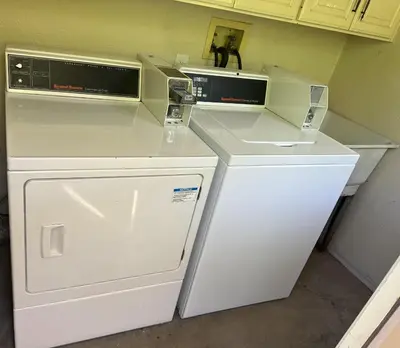 two washer and dryers sitting on top of a counter at Designer Poolside 1Bed1Bth Retreat in La Mesa