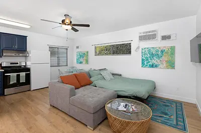 a living room with a couch and a kitchen at Designer Poolside 1Bed1Bth Retreat in La Mesa
