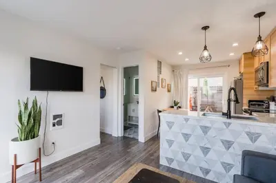 a kitchen and living room with a bar and a tv at Casa Nova - Central San Diego FREE parking in San Diego