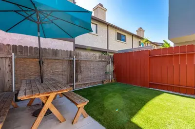a picnic table with an umbrella in a backyard at Casa Nova - Central San Diego FREE parking in San Diego