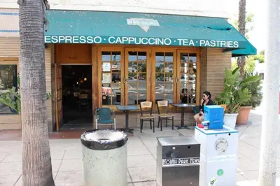 a woman sitting at a table outside of a restaurant at Casa Nova - Central San Diego FREE parking in San Diego