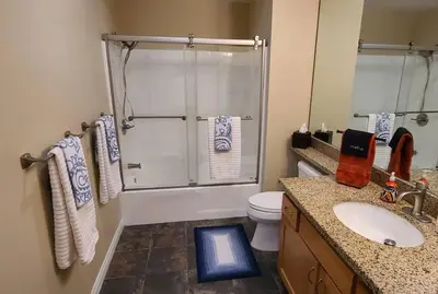 a bathroom with a shower and a toilet and a sink at 28 NIGHT MINIMUM in the Gaslamp Quarter by Petco Park, pool, jacuzzi, dogs ok in San Diego