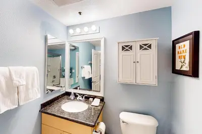 a bathroom with a sink and a toilet and a mirror at San Diego's Diamond in San Diego