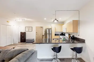 a kitchen and living room with a couch and a counter at San Diego's Diamond in San Diego