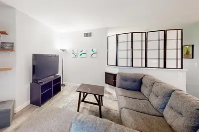 a living room with a couch and a tv at San Diego's Diamond in San Diego