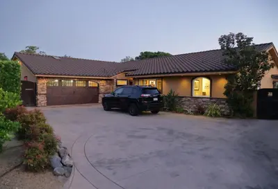 a car parked in front of a house at Cottage On The Greens - Studio in Poway