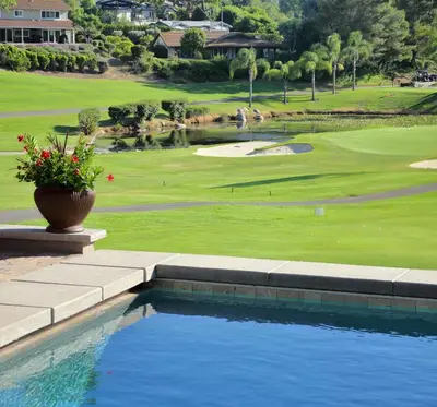 a swimming pool in front of a golf course at Cottage On The Greens - Studio in Poway