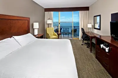 a hotel room with a bed and a desk with a view at Wyndham San Diego Bayside in San Diego