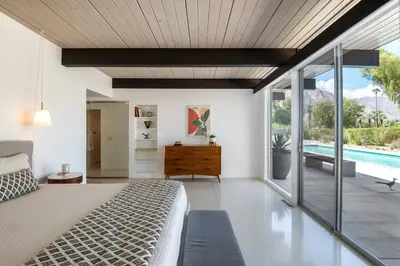 a bedroom with a bed and a swimming pool at The Milky Way Modern Desert Retreat in Borrego Springs