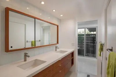 a bathroom with two sinks and a mirror at The Milky Way Modern Desert Retreat in Borrego Springs